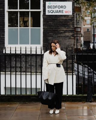 @annacascarina wearing a white blazer and trousers