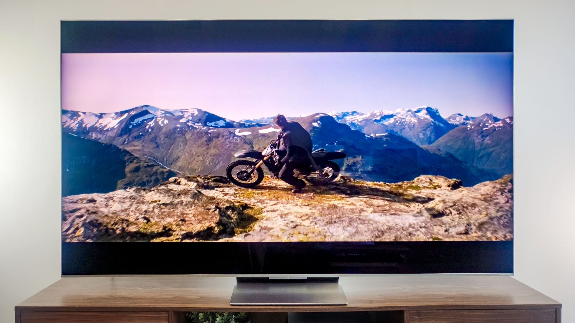 A TCL QM9K TV on a side table