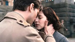 Henry holds Julia's face in his hands, their foreheads pressed together