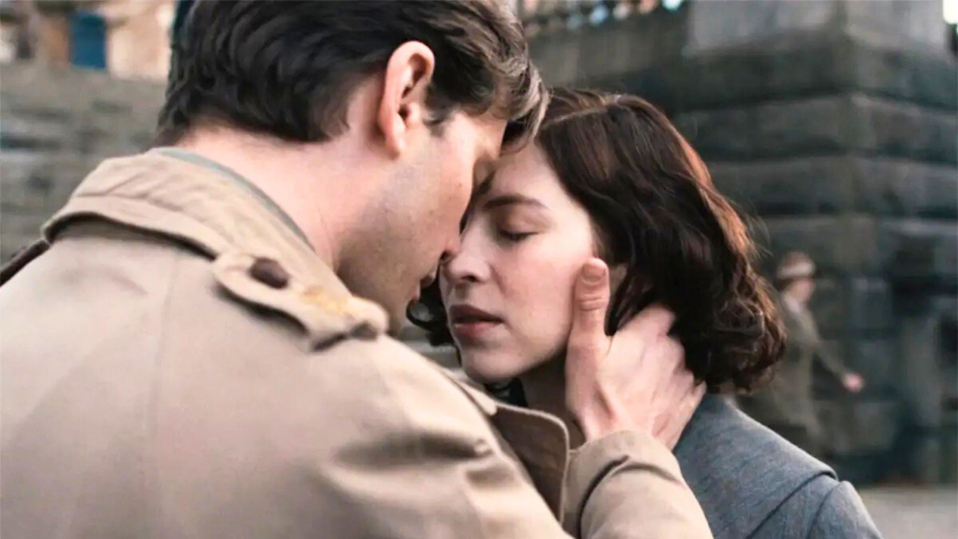 Henry holds Julia's face in his hands, their foreheads pressed together
