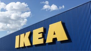 IKEA sign on a wall with cloudy sky in background