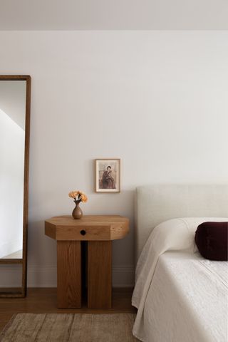 Minimalist bedroom with wooden side table