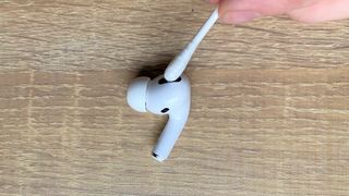 Using a cotton bud to clean the apple airpods pro