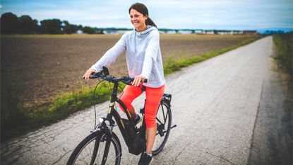 Woman riding on the electric bicycle