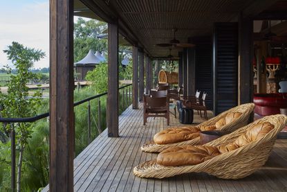 Xigera Safari Lodge patio with chairs by Porky Hefer