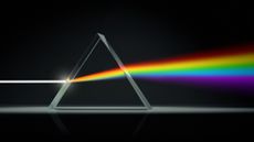 A prism splitting white light into the color spectrum (rainbow).