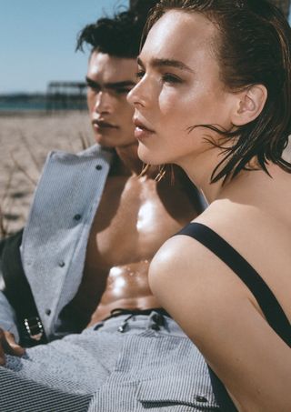 Woman in Armani swimsuit with man