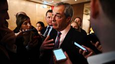 Nigel Farage surrounded by journalists