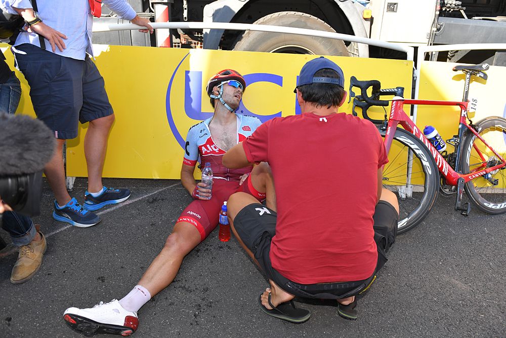 Rick Zabel (Katusha-Alpecin) sits on the ground at the finish of stage 11 after officials announce he could stay in the race after narrowly missing the time cut