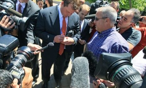 Roger Clemens signs a baseball outside the courthouse, after his case was declared a mistrial Thursday.