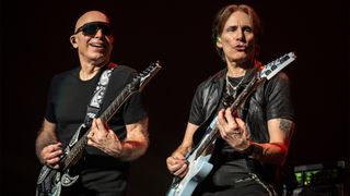 A photo of Joe Satriani (keft) and Steve Vai (right) performing onstage