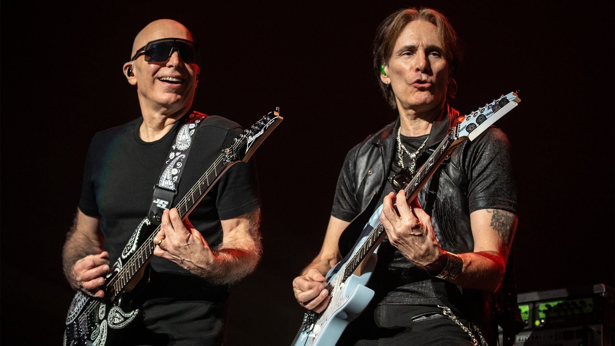 A photo of Joe Satriani (keft) and Steve Vai (right) performing onstage