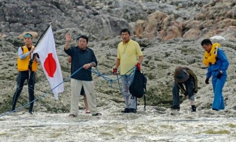 Unidentified members of a Japanese nationalist group land on a disputed island in the East China Sea.