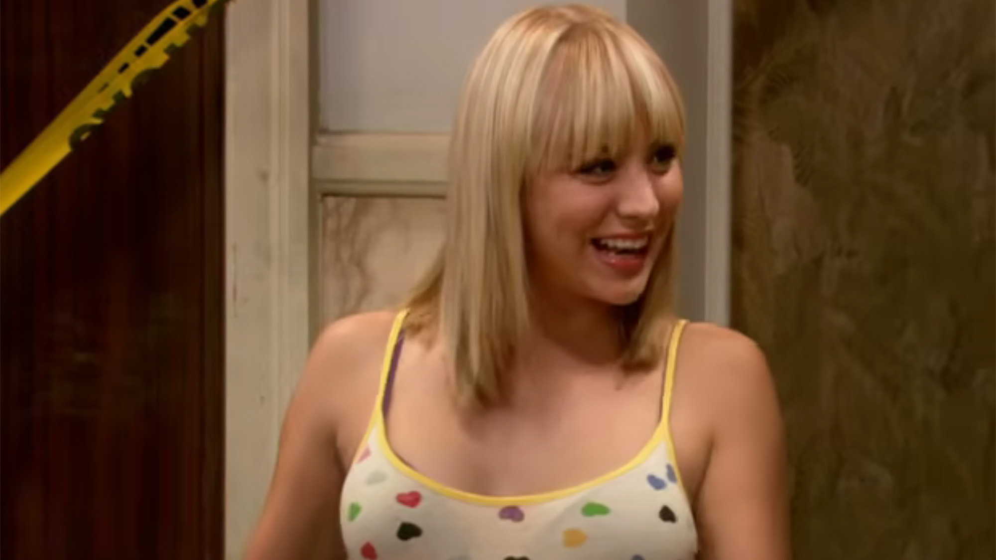 Kaley Cuoco in a heart tank top with bangs in The Big Bang Theory pilot.