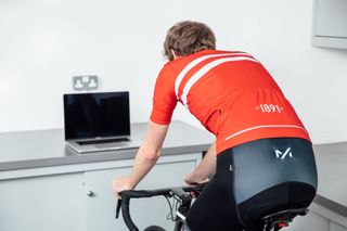 Image shows a rider staying seated in a bike saddle during a turbo training session.