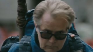 Martin Sheen wearing sunglasses with a backpack on in The Way