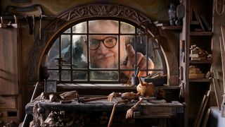 animation rules; director del toro peers through a window of a model