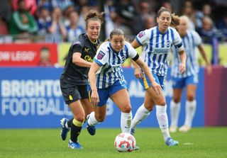 Fran kirby chasing after a ball in a Brighton game