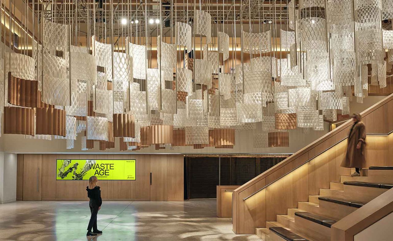 Installation by Arthur Mamou-Mani featuring modular partitions hanging over the design museum&#039;s atrium in London