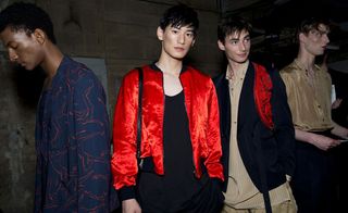 Male models wearing red and blue jackets and from the Dries Van Noten SS2015 collection