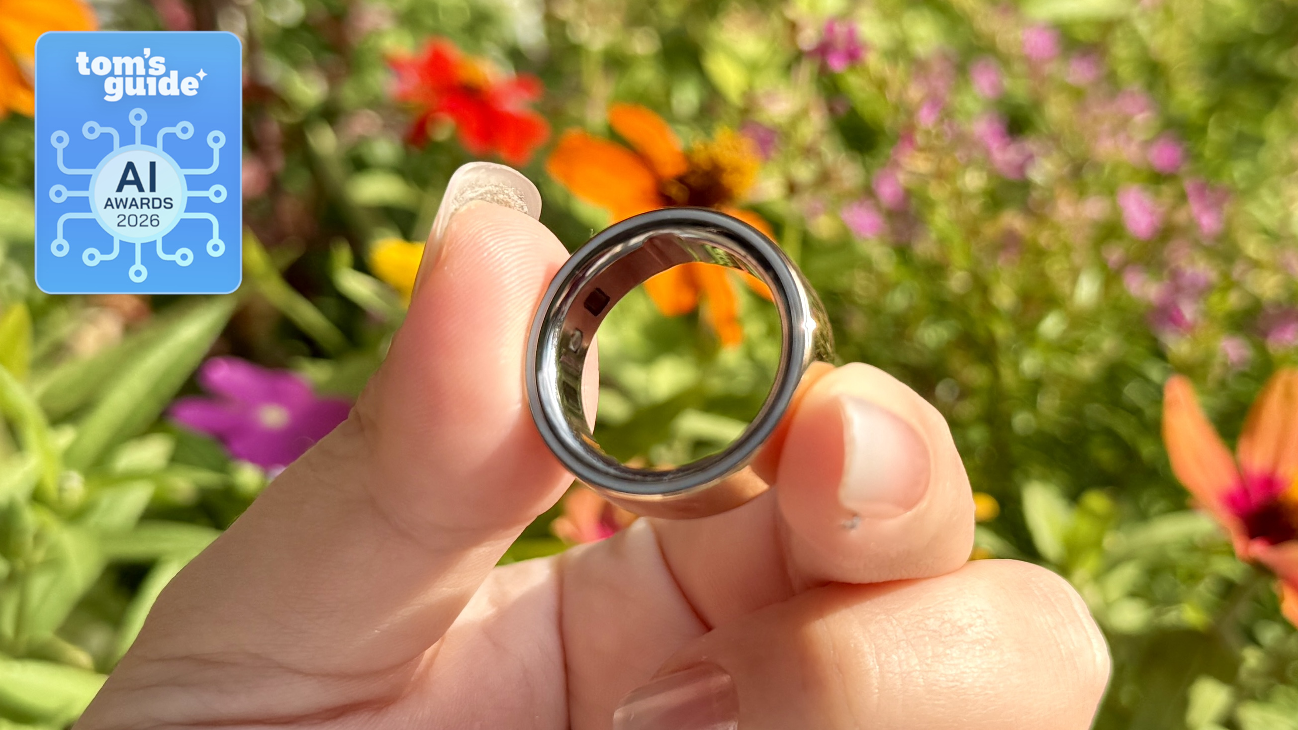 The Oura Ring 4 in hand with a Tom's Guide AI Awards 2026 badge