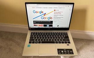 Acer Swift 1 laptop open on a stool with Creative Bloq on screen