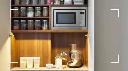 beige kitchen showing an integrated microwave inside a pantry cupboard to support a guide on how to clean a microwave