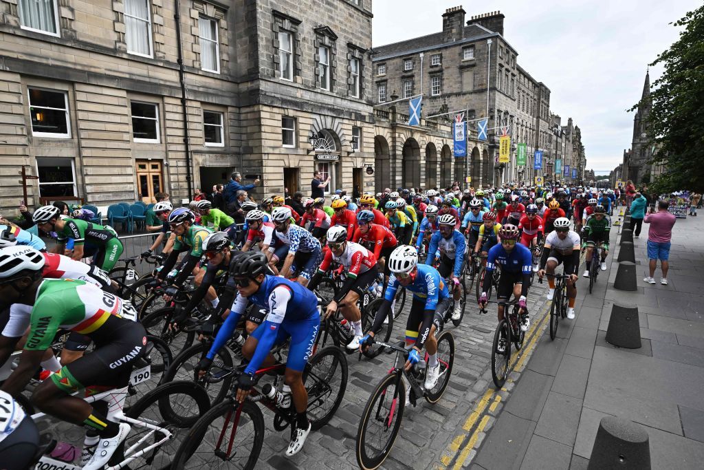Riders cycle down the Royal Mile at the start of the mens Elite Road Race at the Cycling World Championships in Edinburgh Scotland on August 6 2023 Photo by Oli SCARFF AFP Photo by OLI SCARFFAFP via Getty Images