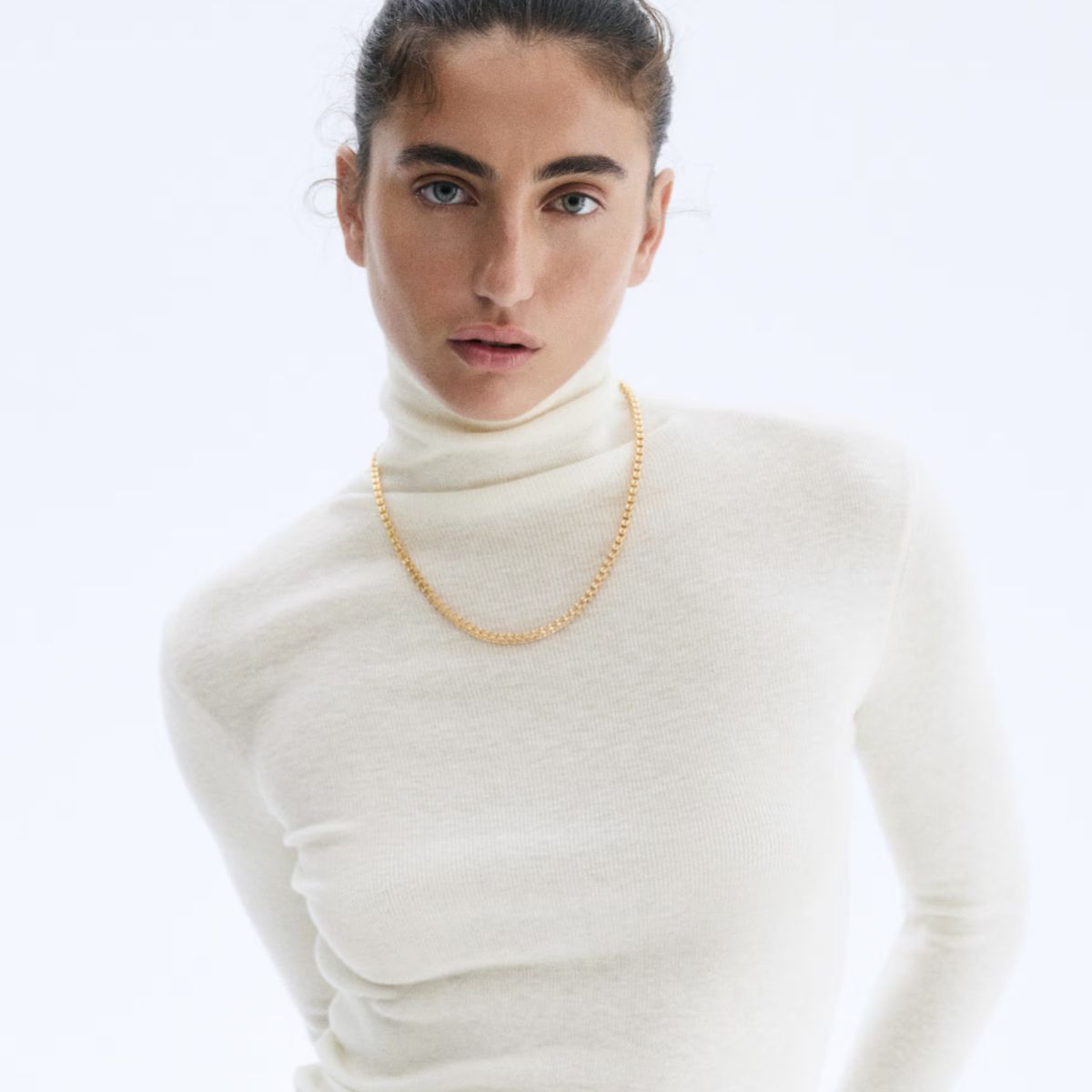 Model wearing white cashmere top