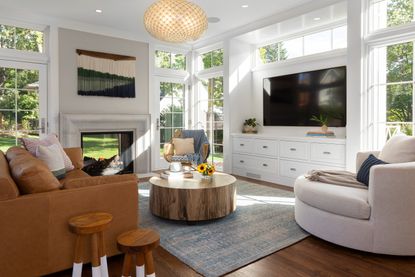 white living room with indoor outdoor fireplace and TV