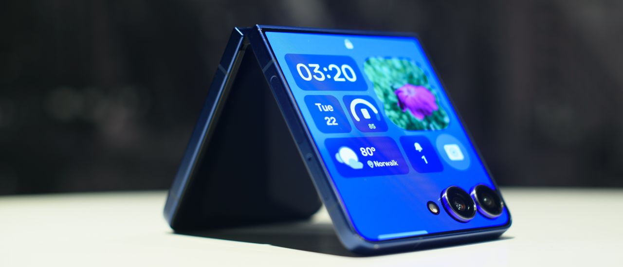 Samsung Galaxy Z Flip 7 in blue folded showing widgets on the cover display