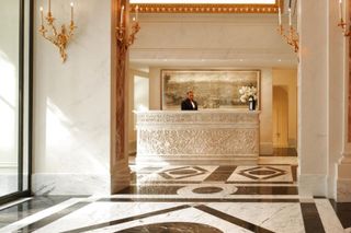 The grand marble and gold gilt lobby at Hotel Eden