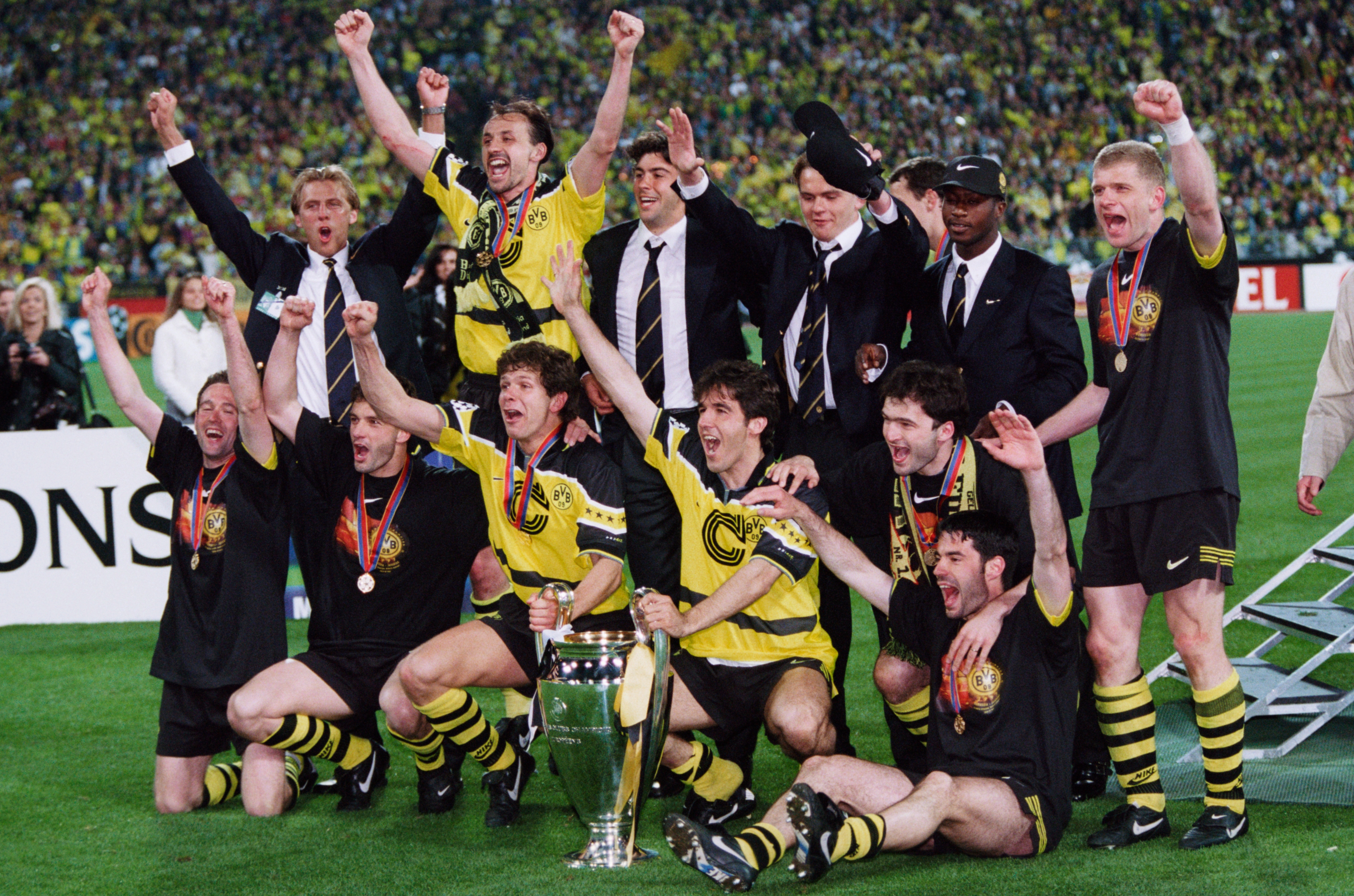 Borussia Dortmund celebrate with the trophy after winning the 1997 Champions League final against Juventus