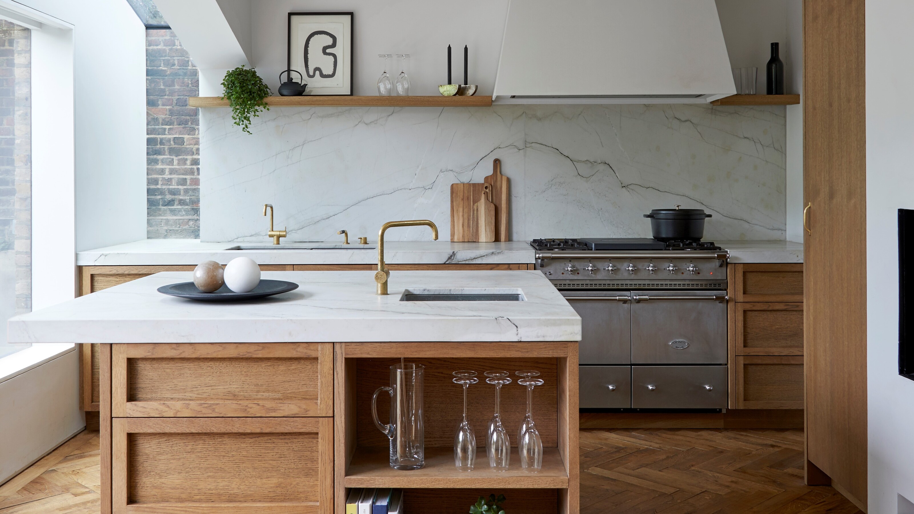 Unpainted wooden kitchen cabinets with open shelving as well as an island in the middle 