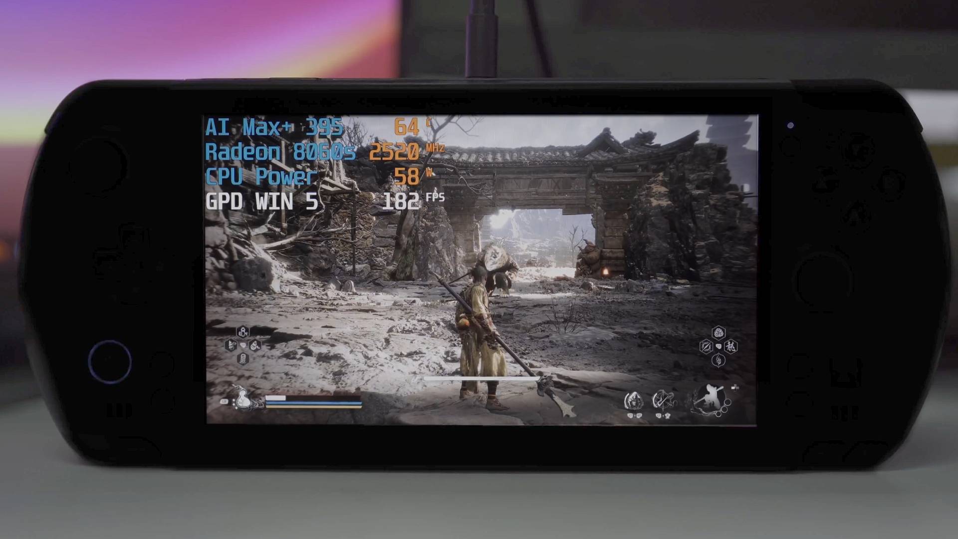 GPD WIN 5 handheld in low lighting with Blackmyth: Wukong gameplay on screen.