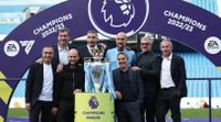 Pep Guardiola and his Manchester City staff celebrate with the Premier League trophy in May 2023.