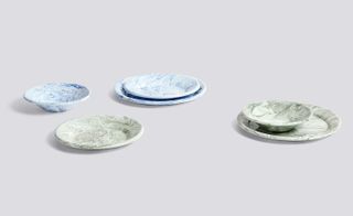The eclectic tabletop pieces include enamelware with marble-like patterns