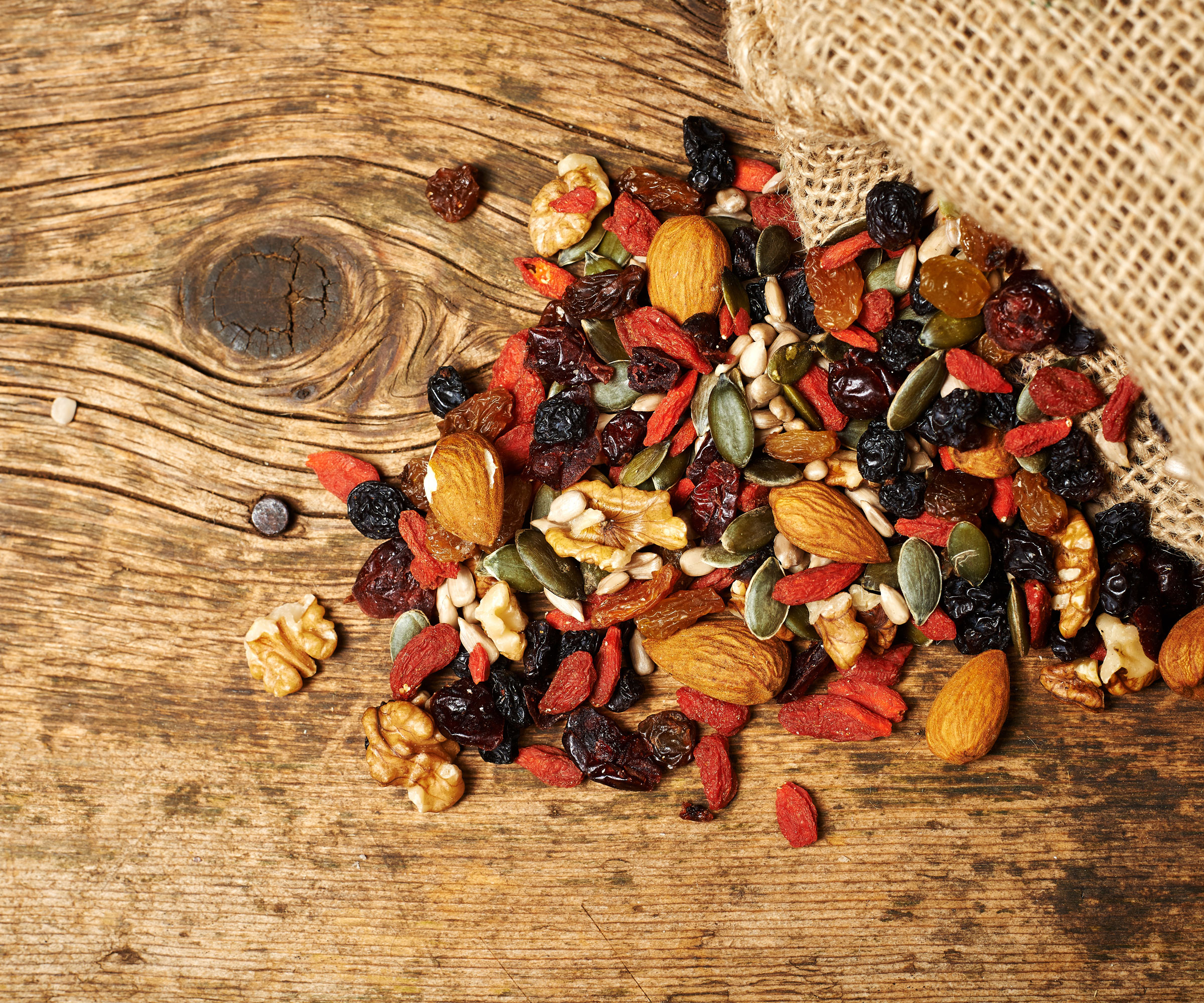 nuts and berries and seeds on wooden table