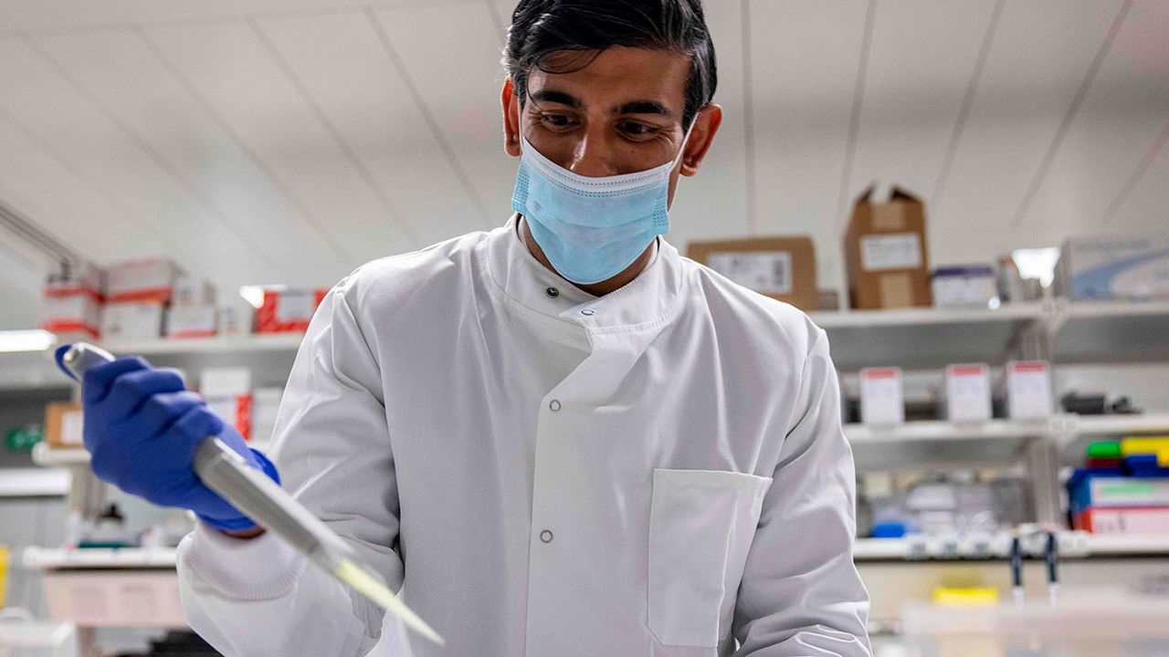 Rishi Sunak dressed up as a nurse holding a big pointy thing