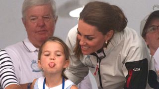 Princess Charlotte of Cambridge sticks out her tongue much to the amusement of her mother Catherine, Duchess of Cambridge, following the inaugural King's Cup regatta hosted by the Duke and Duchess of Cambridge on August 08, 2019 in Cowes, England.