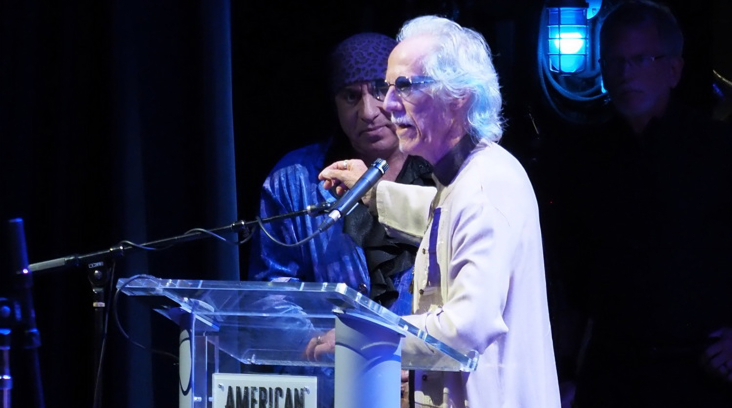 Doors drummer John Densmore speaks at the 2026 American Music Honors as Steve Van Zandt looks on