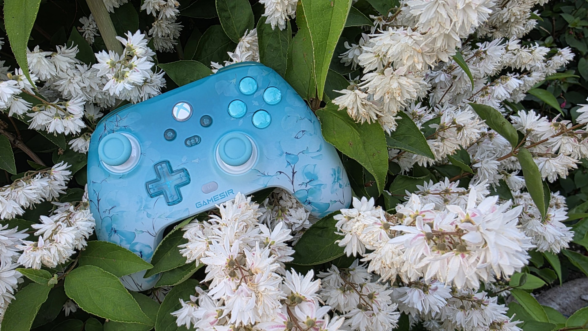 A blue and white controller with floral pattern
