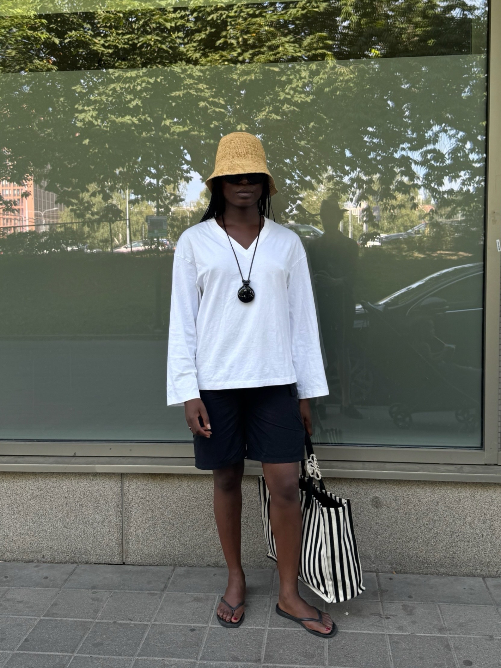 Influencer Chrystelle Eriksberger wearing a white v-neck t-shirt.