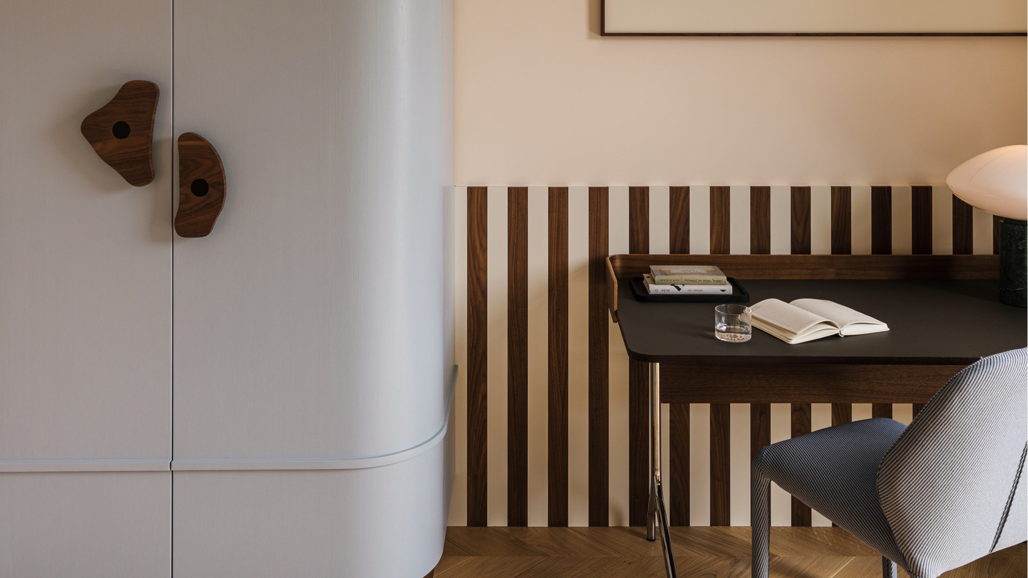 a light blue cabinet with wood handles and a wood striped wall
