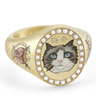 a signet ring with a cat and travis kelce's kansas city chiefs number