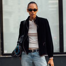 Women in jacket, jeans, and boots. 