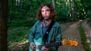 A portrait of Daniel Donato with a Surf Green Telecaster in the forest