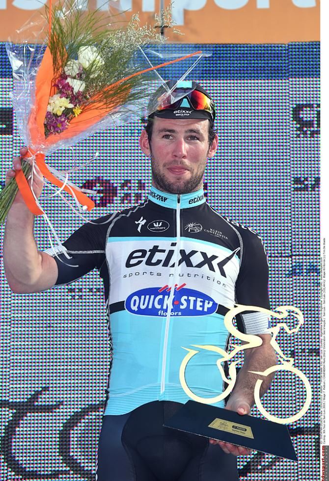 Mark Cavendish (Etixx-QuickStep) is awarded flowers and a cycling trophy