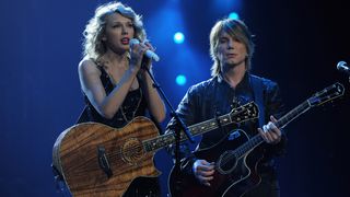 NEW YORK, NY - NOVEMBER 21: Taylor Swift and Johnny Rzeznik of the Goo Goo Dolls perform during the "Speak Now World Tour" at Madison Square Garden on November 21, 2011 in New York City. Taylor Swift wrapped up the North American leg of her SPEAK NOW WORLD TOUR with two sold-out shows at Madison Square Garden this week. In 2011, the tour played to capacity crowds in stadiums and arenas over 98 shows in 17 countries spanning three continents, and will continue in 2012 with shows Australia and New Zealand. (Photo by Larry Busacca/Getty Images)
