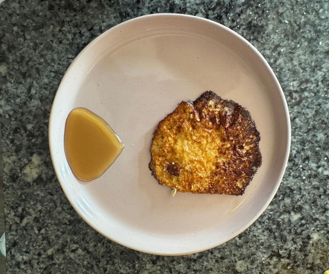 A single pancake on a grey plate